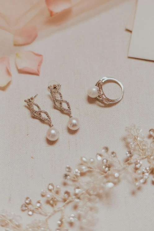 silver diamond studded ring on white textile